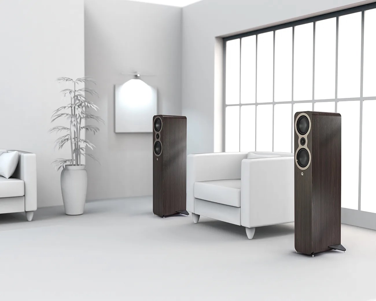 Pair of tall, dark wood floor-standing speakers with black drivers in a bright, minimalist white living room.