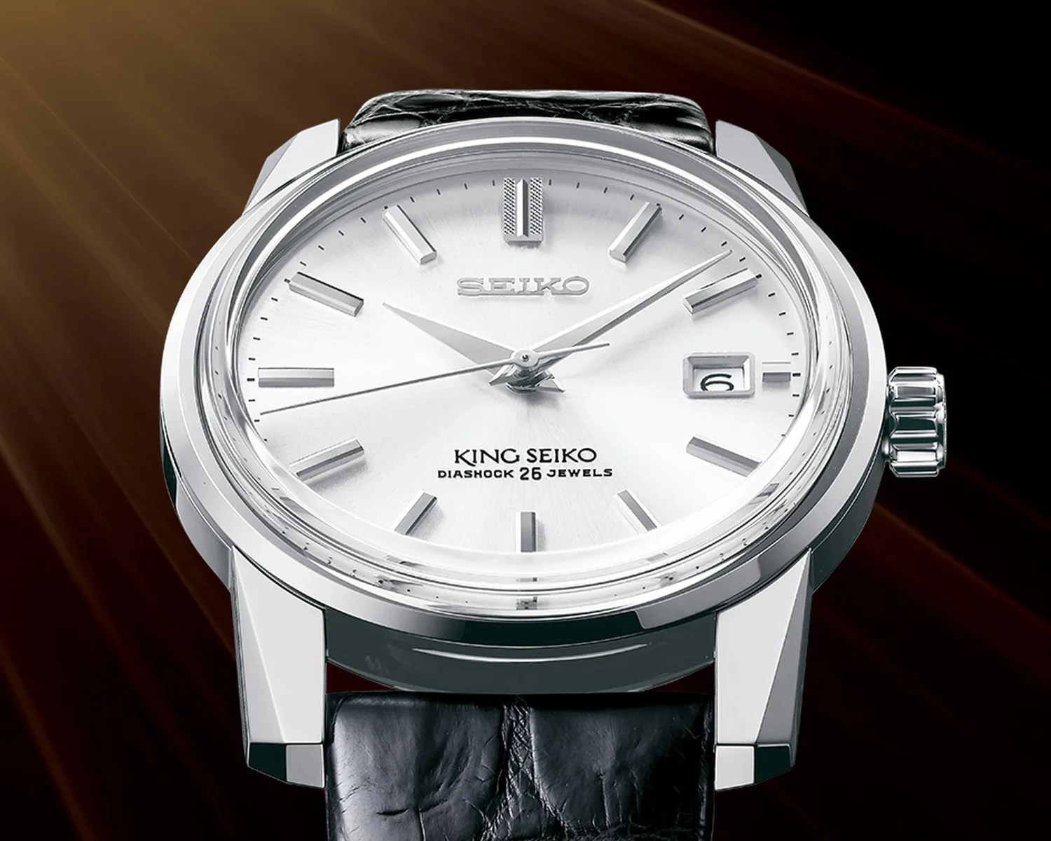 Silver King Seiko wristwatch with black leather strap and date display at 3 o'clock.