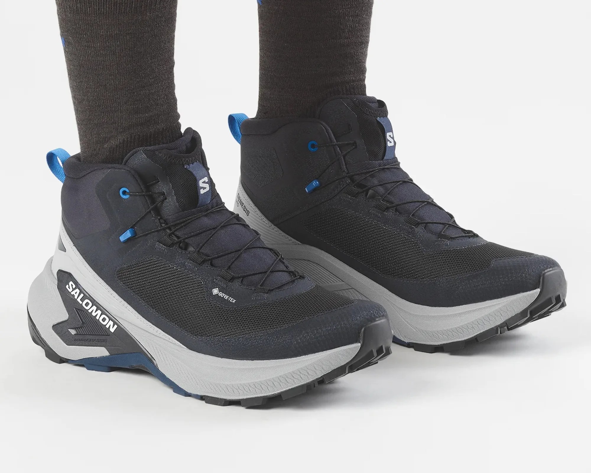 Black and gray Salomon hiking shoes with blue accents and Gore-Tex fabric worn with dark socks.