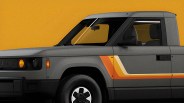 Gray electric pickup truck with orange and yellow retro stripes on the side against a mustard yellow background.