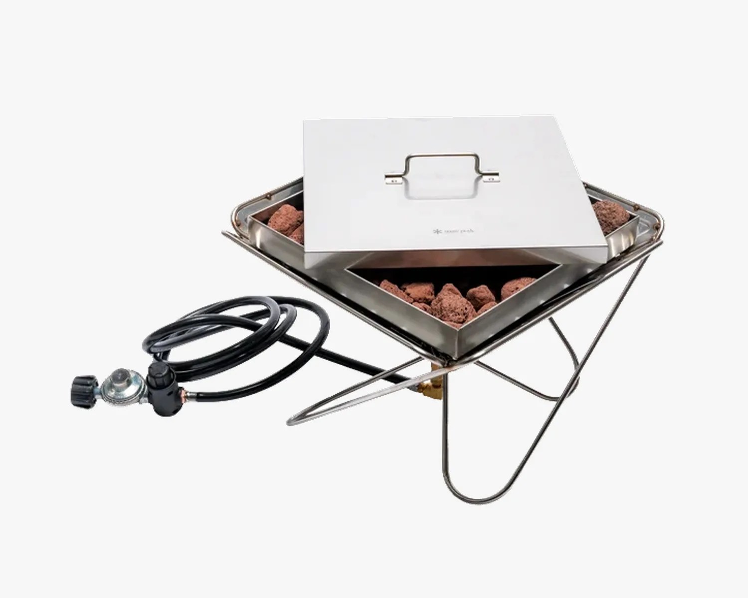 Stainless steel portable gas fire pit with lava rocks and attached regulator hose.