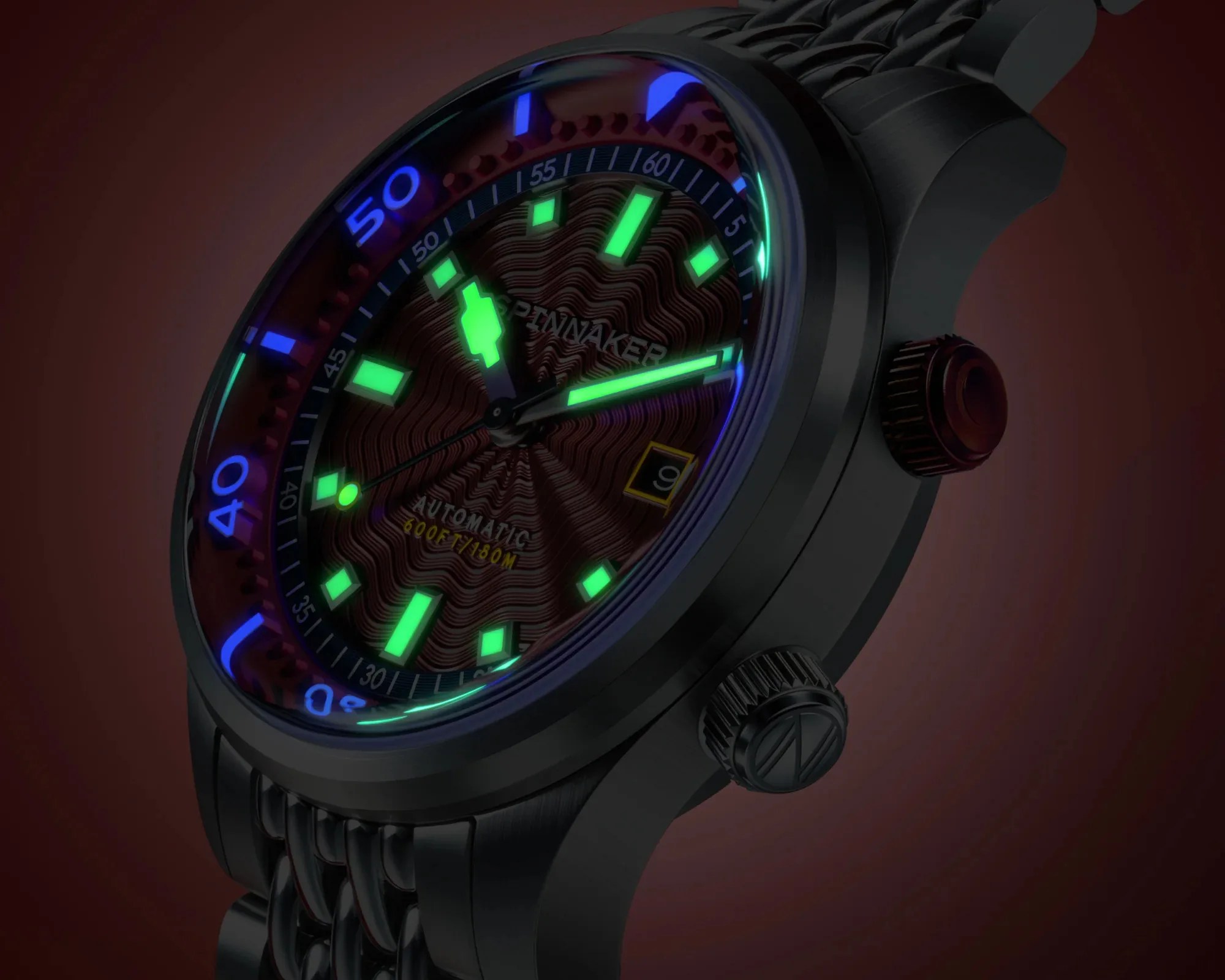 Black metal wristwatch with glowing green and blue markers and a textured dial showing the date.