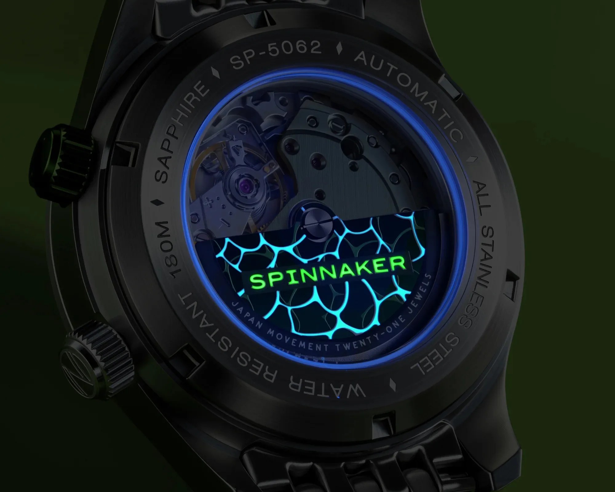 Close-up of the back of a black Spinnaker automatic watch showing the movement through a sapphire crystal case back with blue illumination.