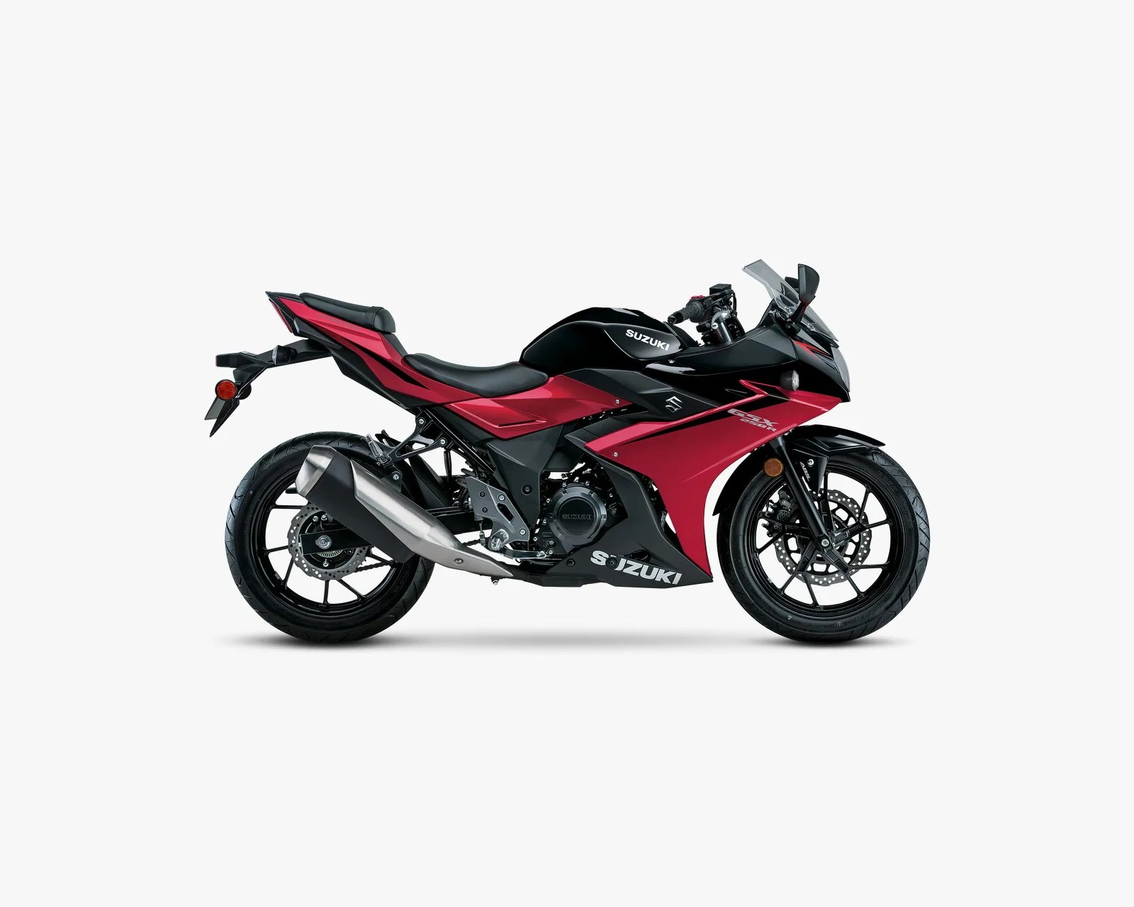Red and black Suzuki GSX motorcycle with sporty fairing and black alloy wheels on a white background.