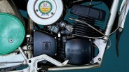 Close-up of a Husqvarna motorcycle engine with black casing and a round silver air filter labeled "G.P Winning Replica.