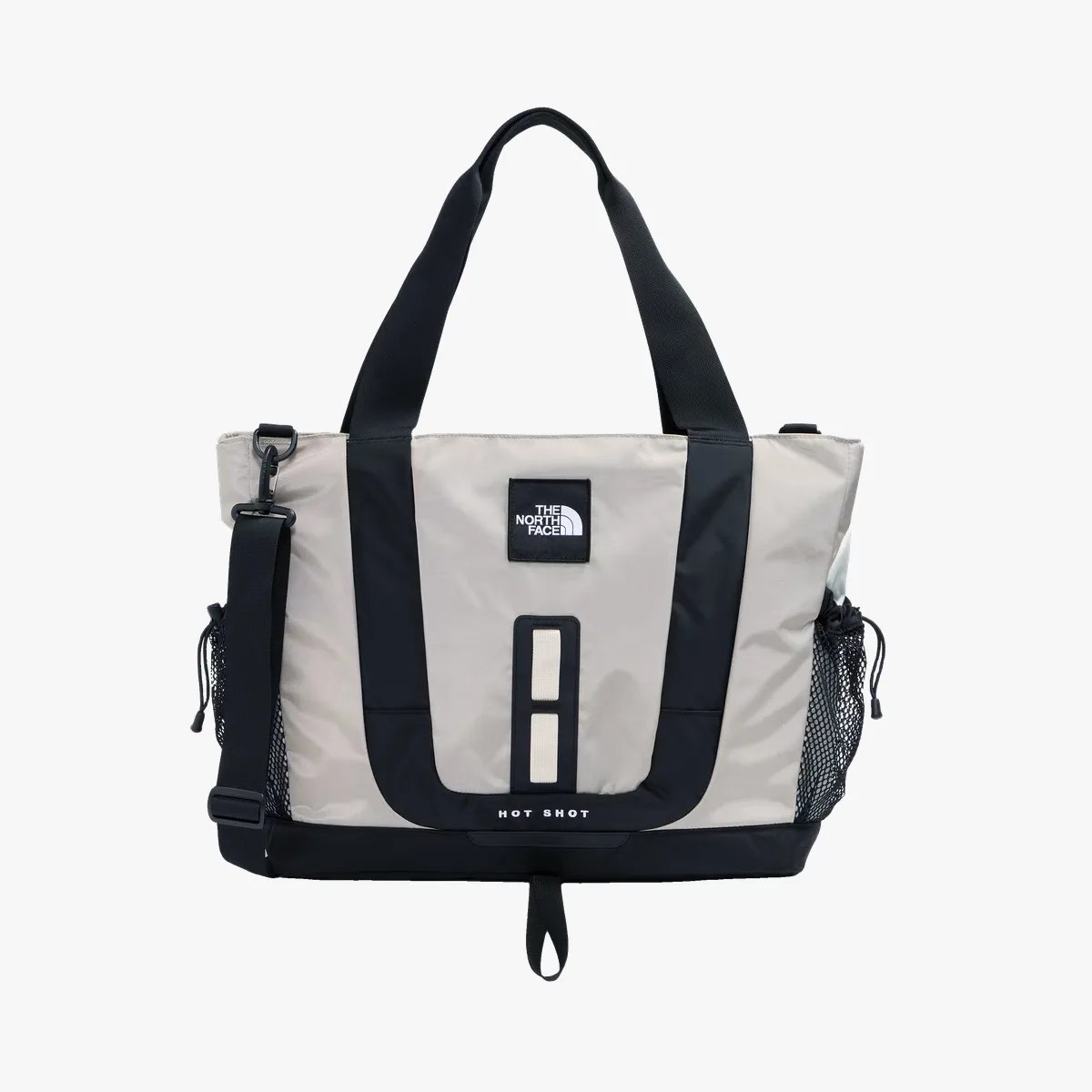 Beige and black The North Face tote bag with dual handles, adjustable shoulder strap, and mesh side pockets.