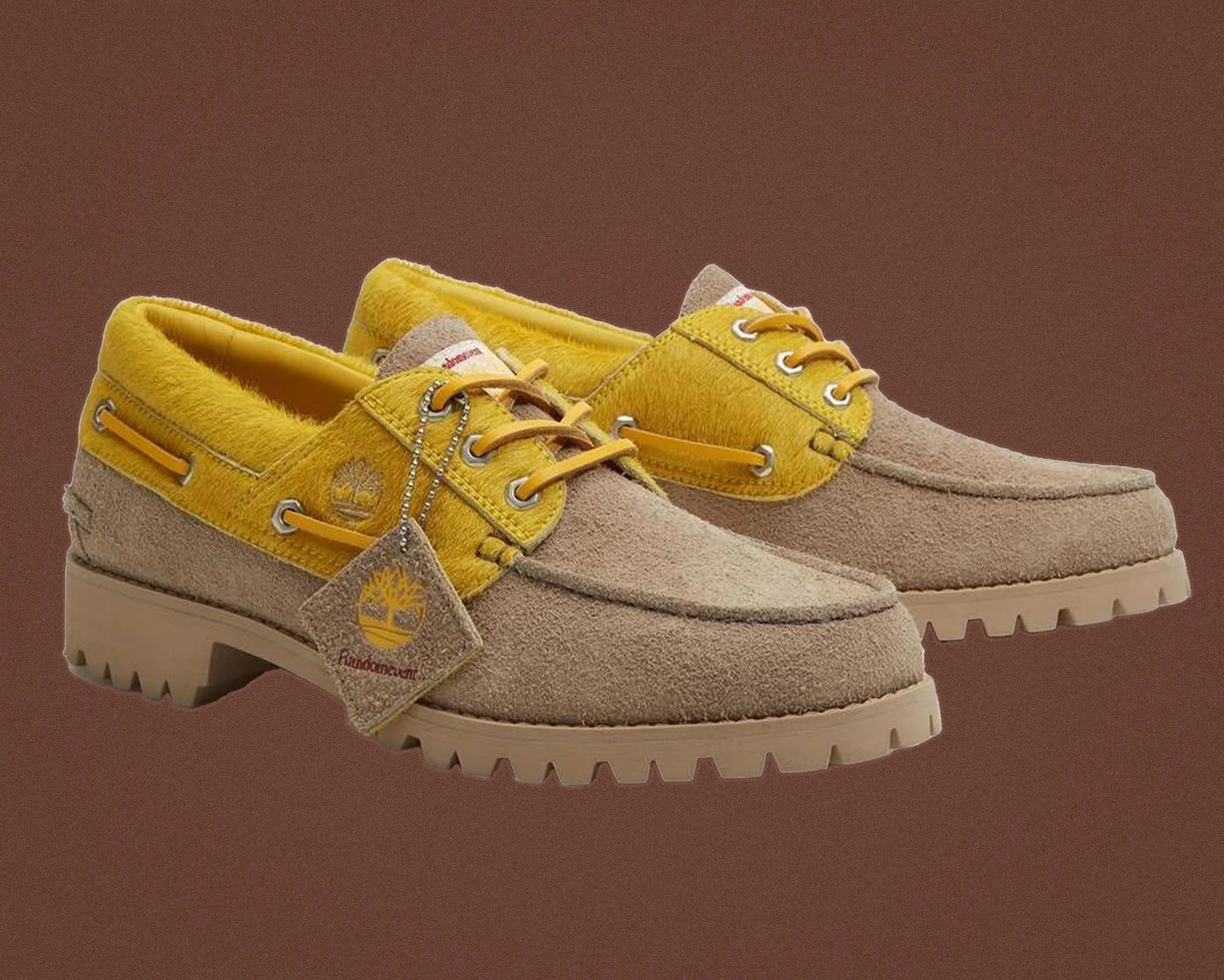 Beige and yellow suede Timberland boat shoes with rugged soles and branded tag.
