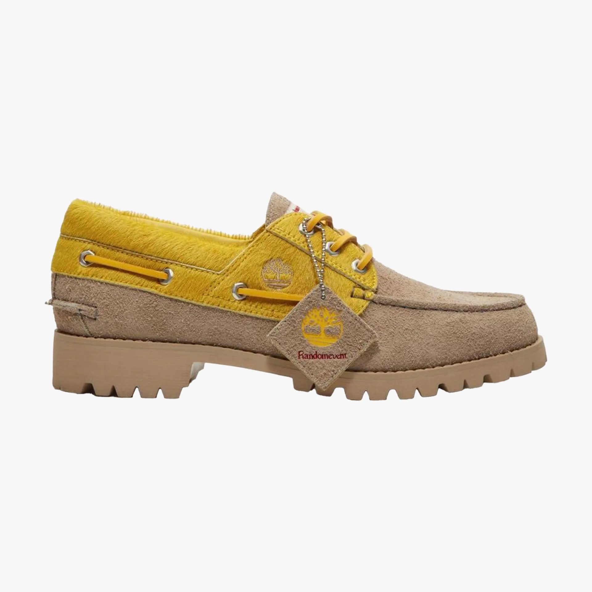Beige and yellow suede boat shoe with rugged sole and Timberland logo on the side and tag.