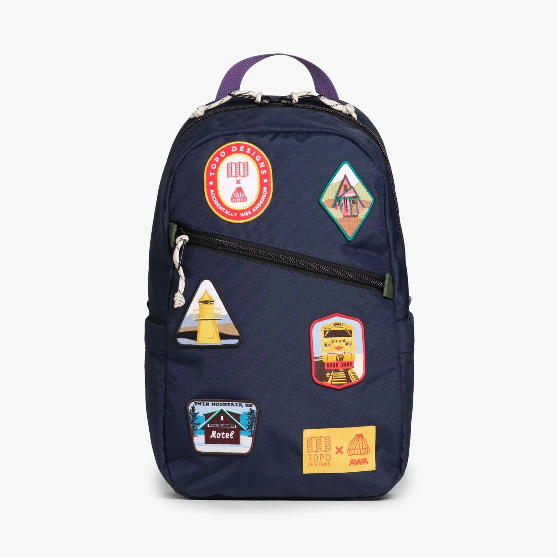 Navy blue backpack with colorful embroidered patches and a purple handle loop.