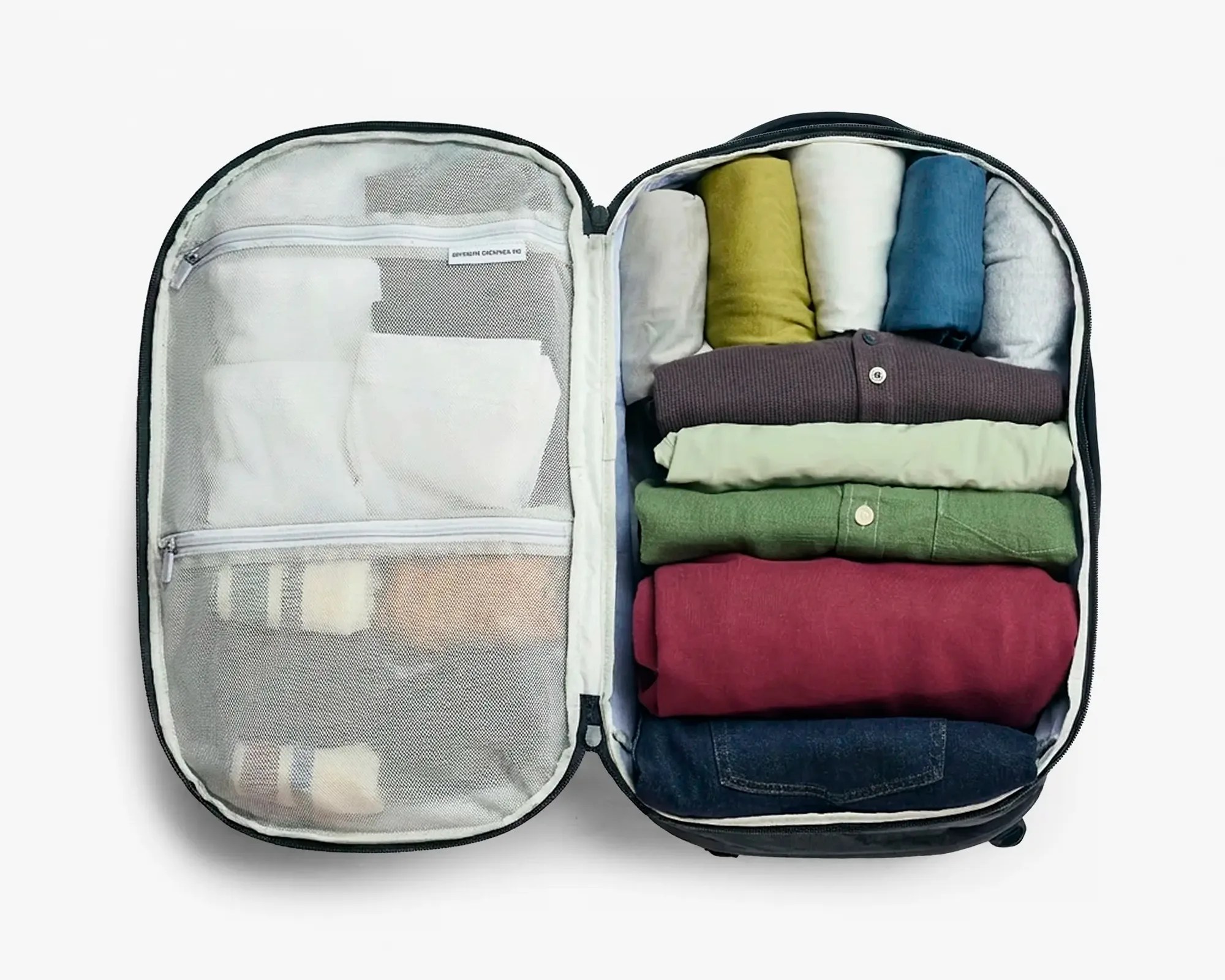 Open black packing cube with neatly folded clothes in various colors inside and mesh zippered compartments on the lid.