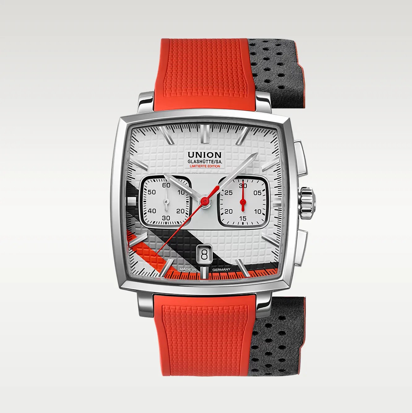 Square silver chronograph watch with white textured dial, black and orange diagonal stripes, and red rubber strap.