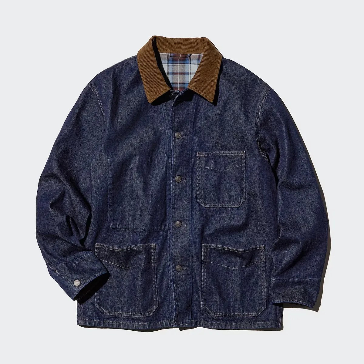 Dark blue denim jacket with brown corduroy collar and three front pockets on a light background.