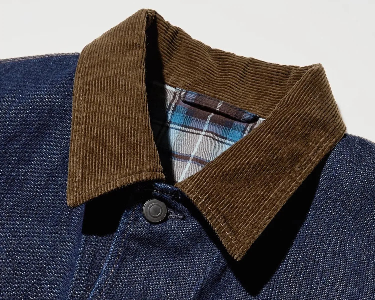 Denim jacket with brown corduroy collar and blue plaid lining visible inside the collar.
