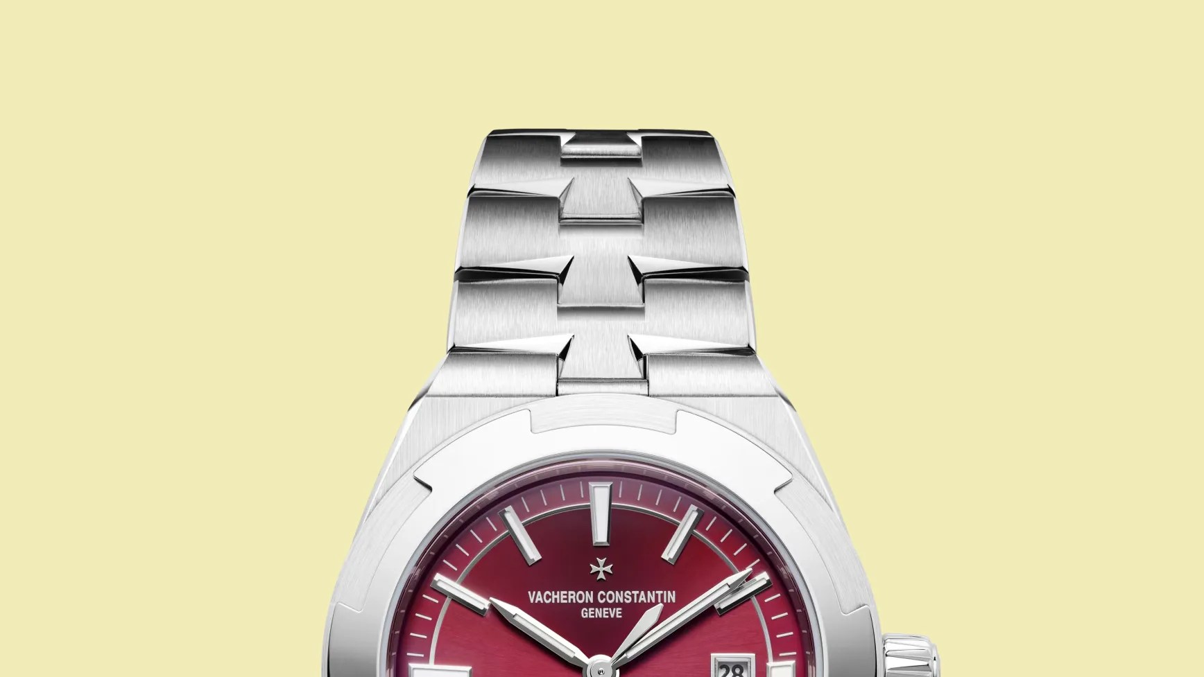 Stainless steel watch bracelet with polished and brushed links attached to a silver case with a red dial.