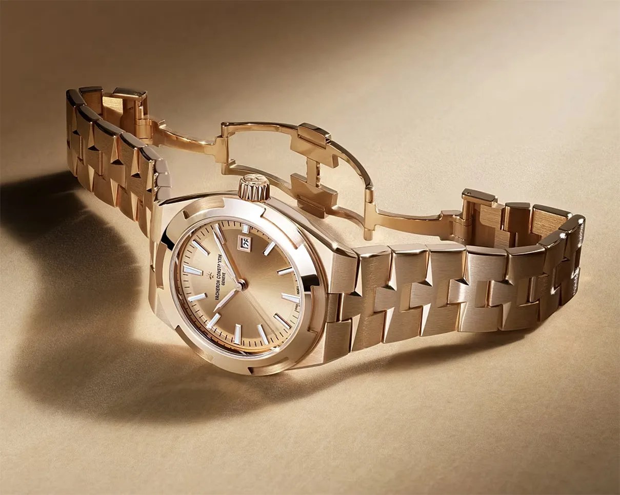 Rose gold wristwatch with a linked bracelet and a round dial showing the date.