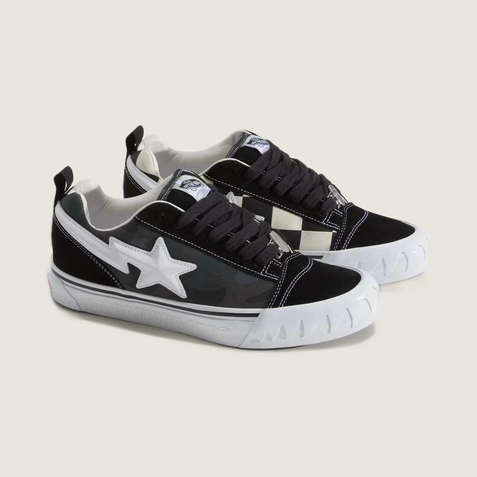 Pair of black and white low-top sneakers with star logo and checkerboard pattern on the sides.