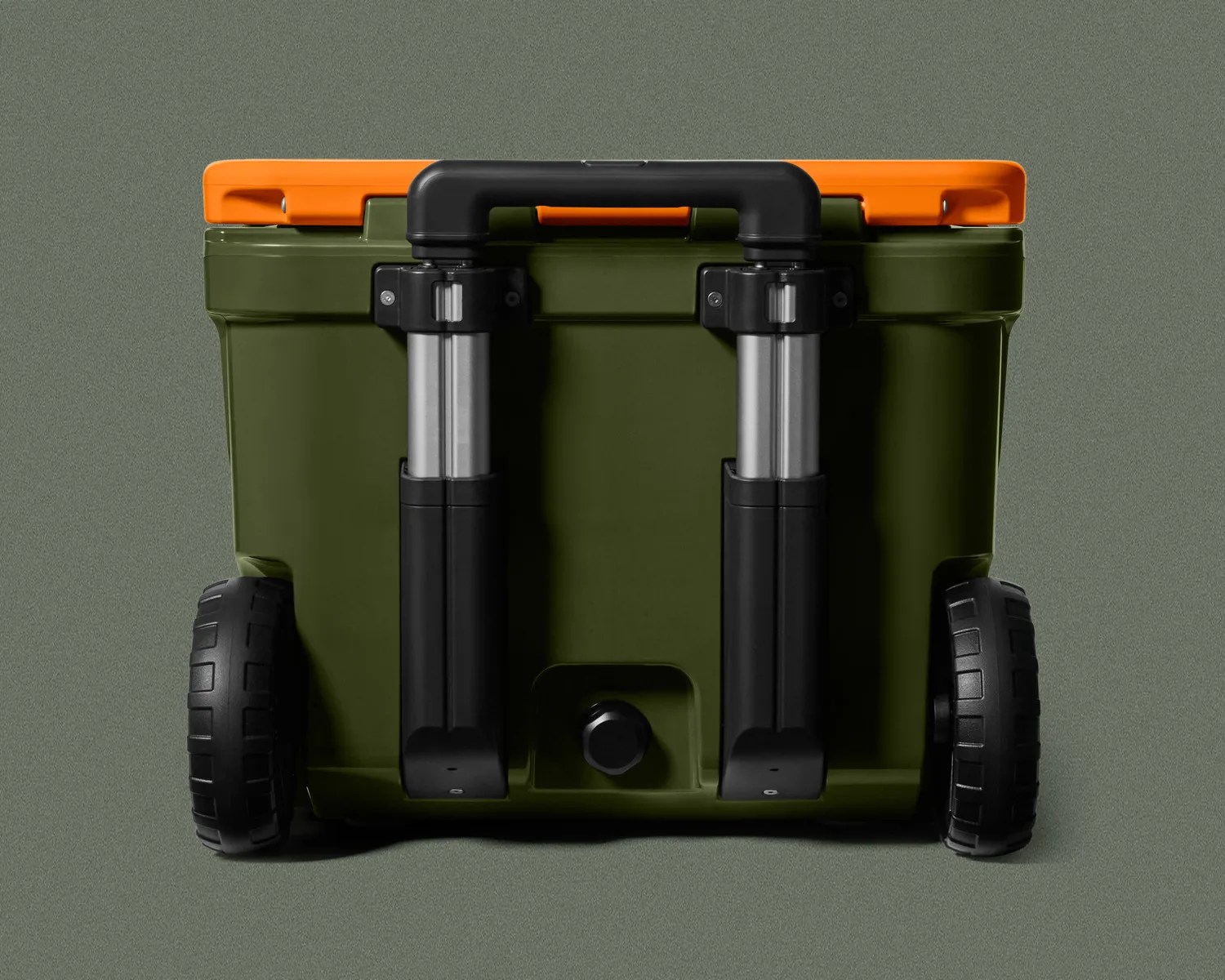 Olive green wheeled cooler with black telescoping handle and orange lid latch on a gray surface.