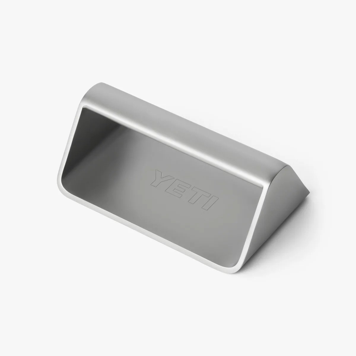 Silver metal YETI-branded bottle opener with a triangular wedge shape.