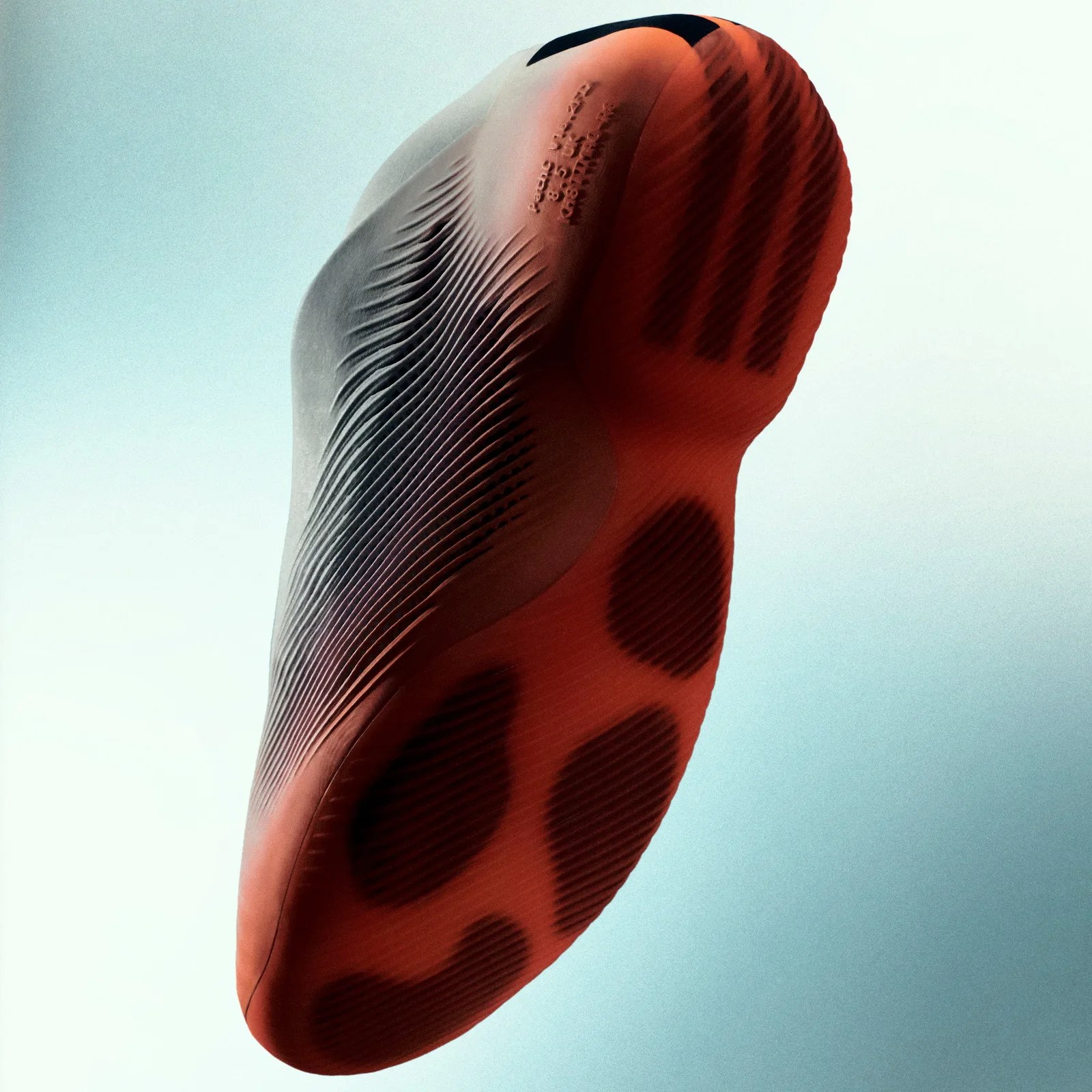 Close-up of the sole of a red and black athletic shoe with textured grip patterns.