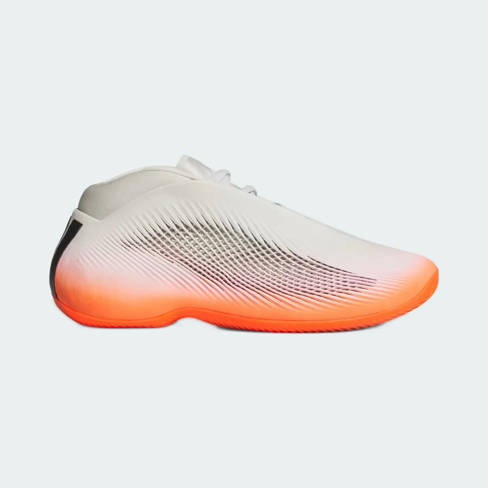 White sneaker with textured sides fading to bright orange sole and black detail on the heel.
