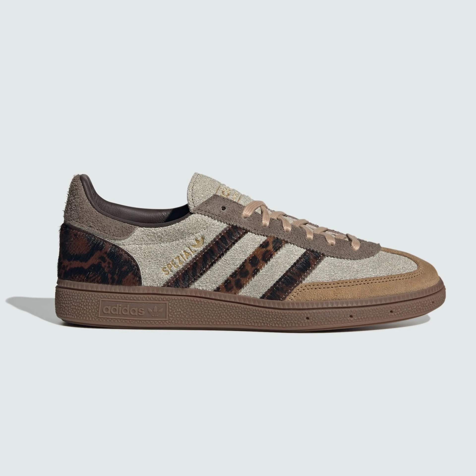 Beige and brown Adidas Spezial sneaker with leopard print stripes and suede accents on a light background.
