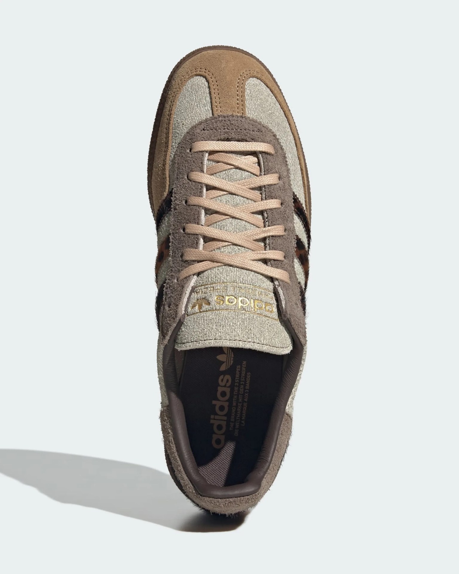 Beige and brown Adidas sneaker with suede and fabric upper, beige laces, and leopard print stripes.