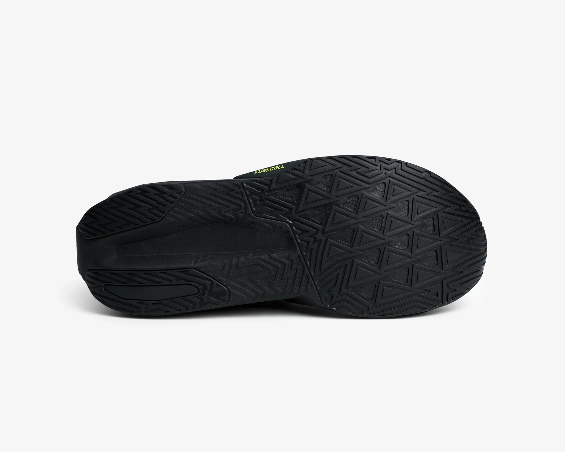 Black rubber shoe sole with geometric tread pattern and yellow "FuelCell" text.