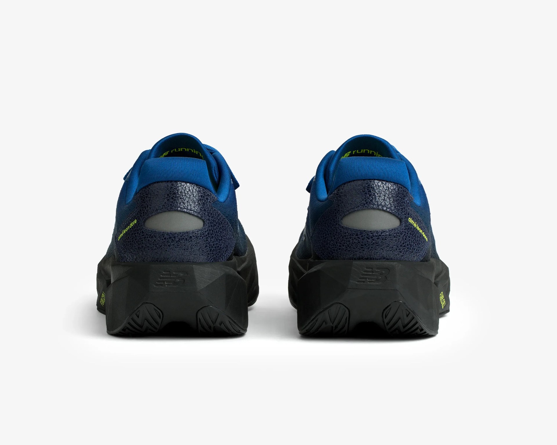 Pair of navy blue and black running shoes with textured heel and thick black soles, viewed from the back.