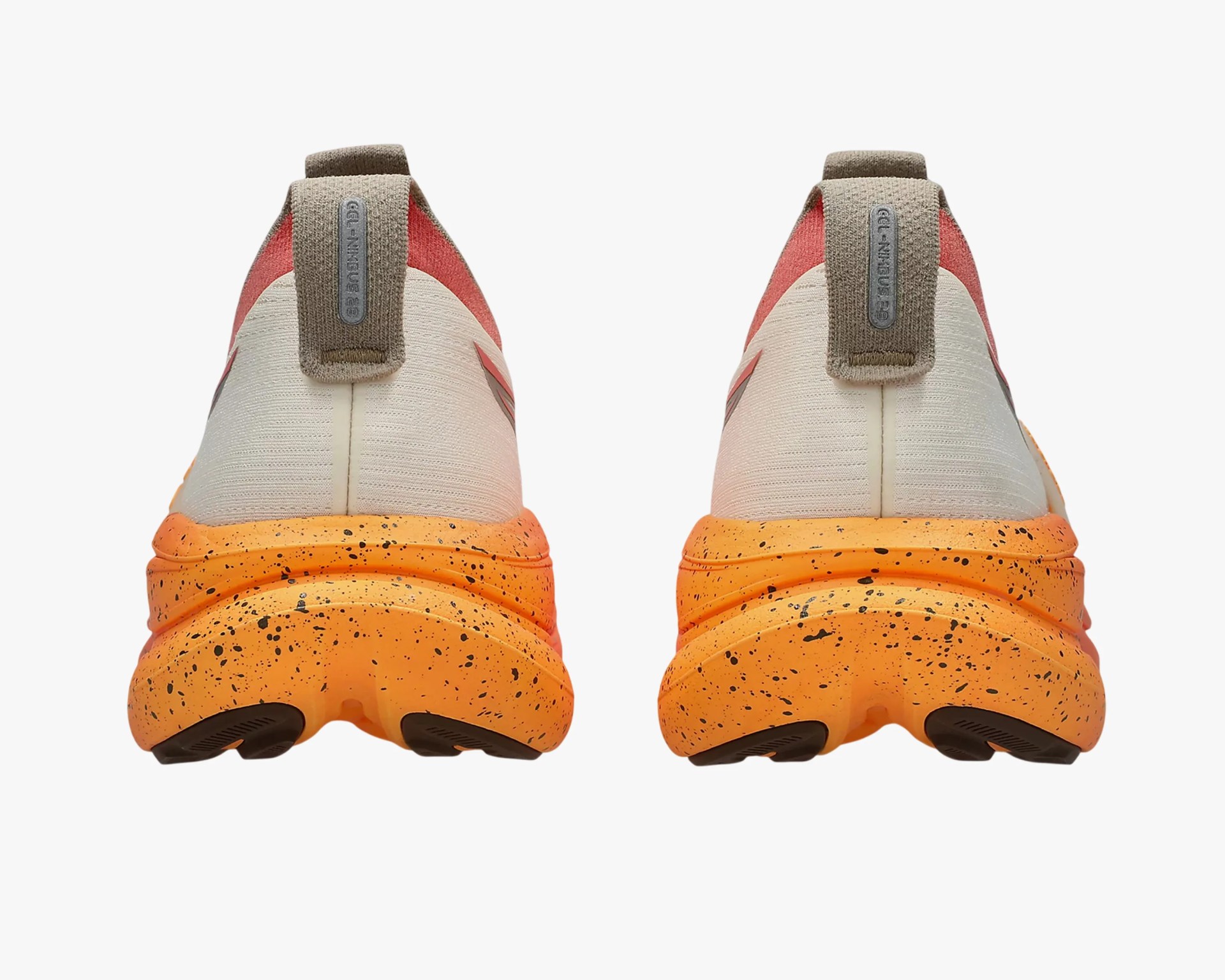 Pair of running shoes with orange speckled soles and beige fabric uppers viewed from the back.