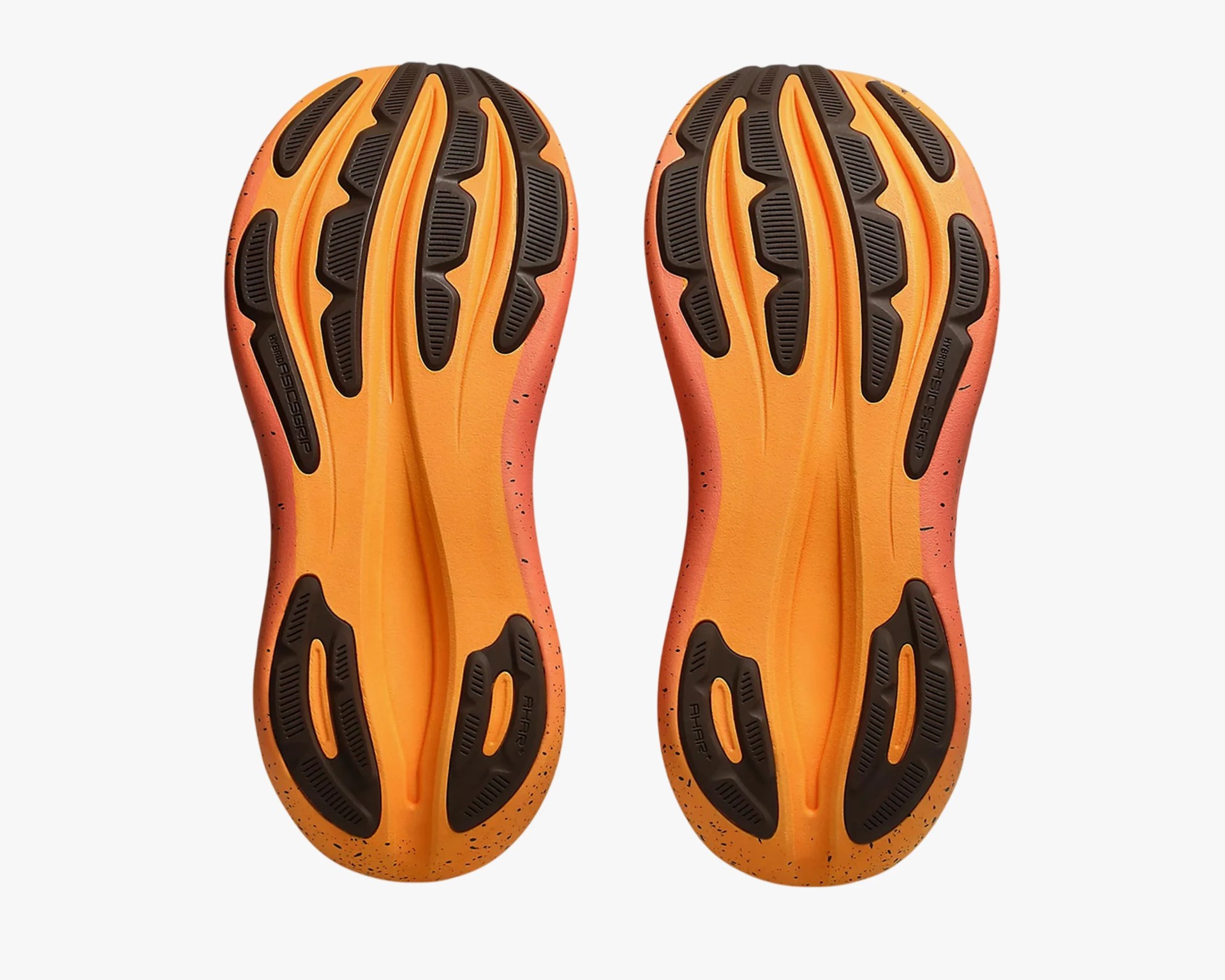Orange and black shoe soles with textured grip patterns and speckled edges.