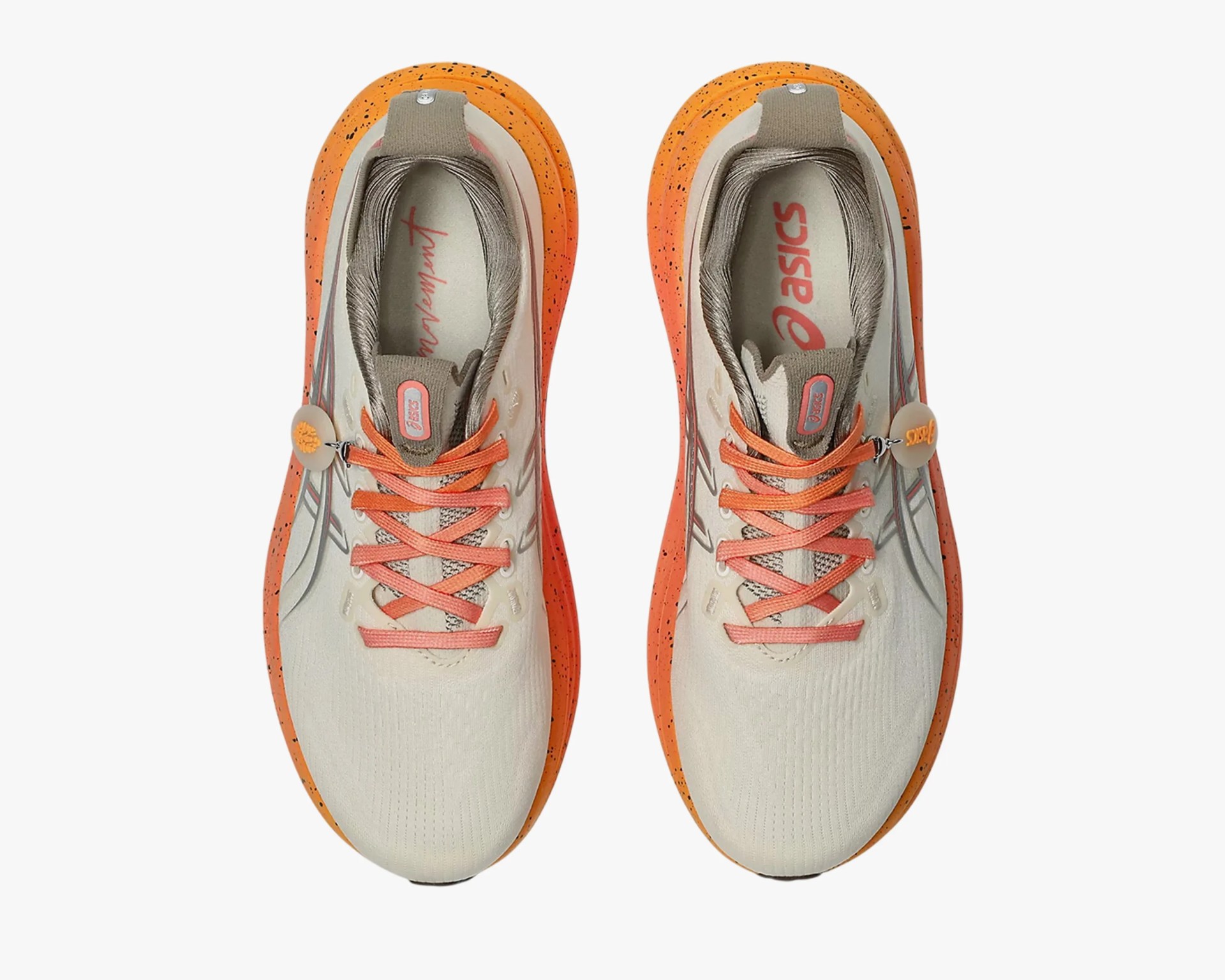 Pair of beige and orange Asics running shoes with orange laces and speckled orange soles viewed from above.