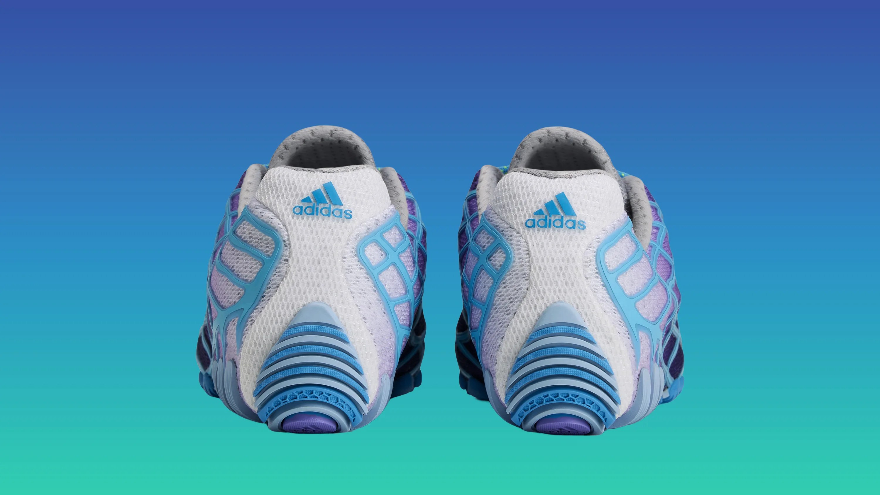 Pair of white and blue Adidas running shoes viewed from the back against a blue gradient background.