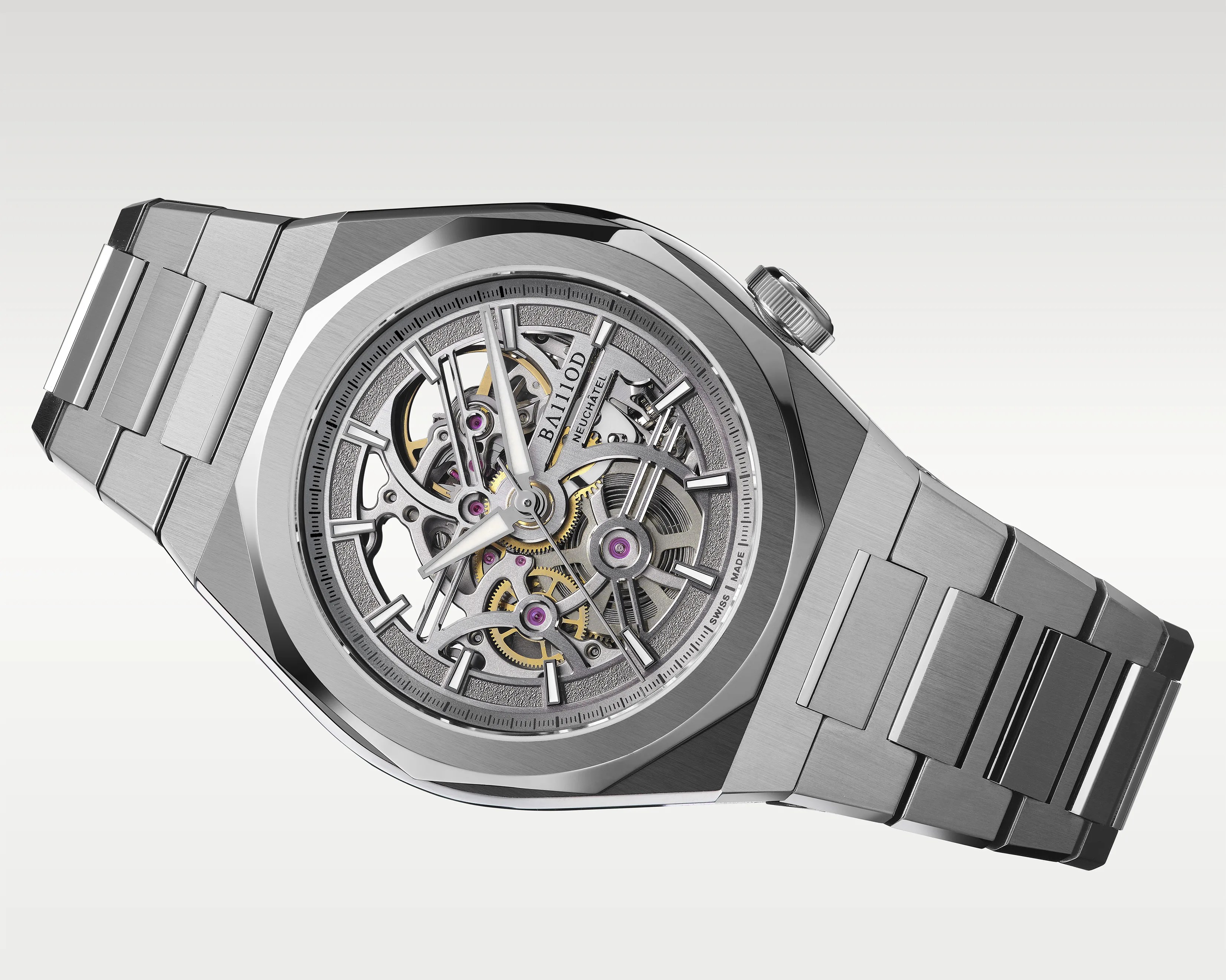 Stainless steel skeleton watch with visible gears and a brushed metal bracelet.
