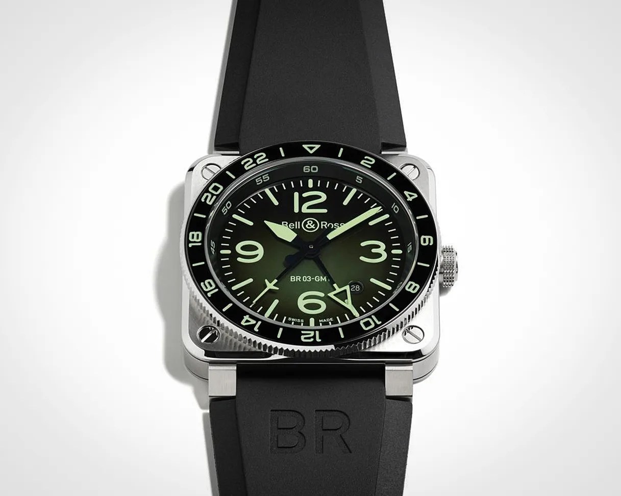 Square stainless steel Bell & Ross BR 03-GMT watch with black dial and black rubber strap.