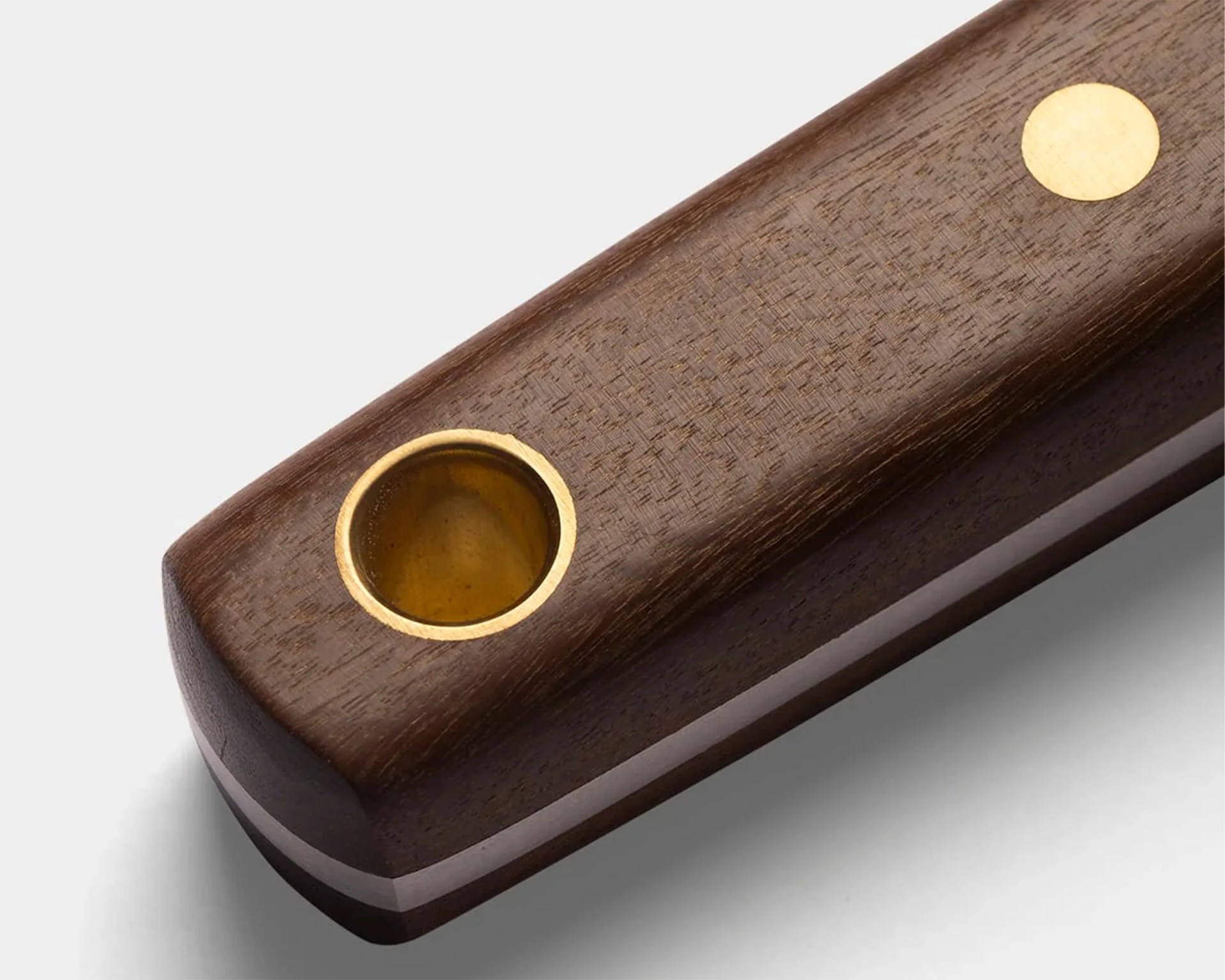 Dark brown wooden pipe with a brass bowl and a brass circular inlay on the handle.