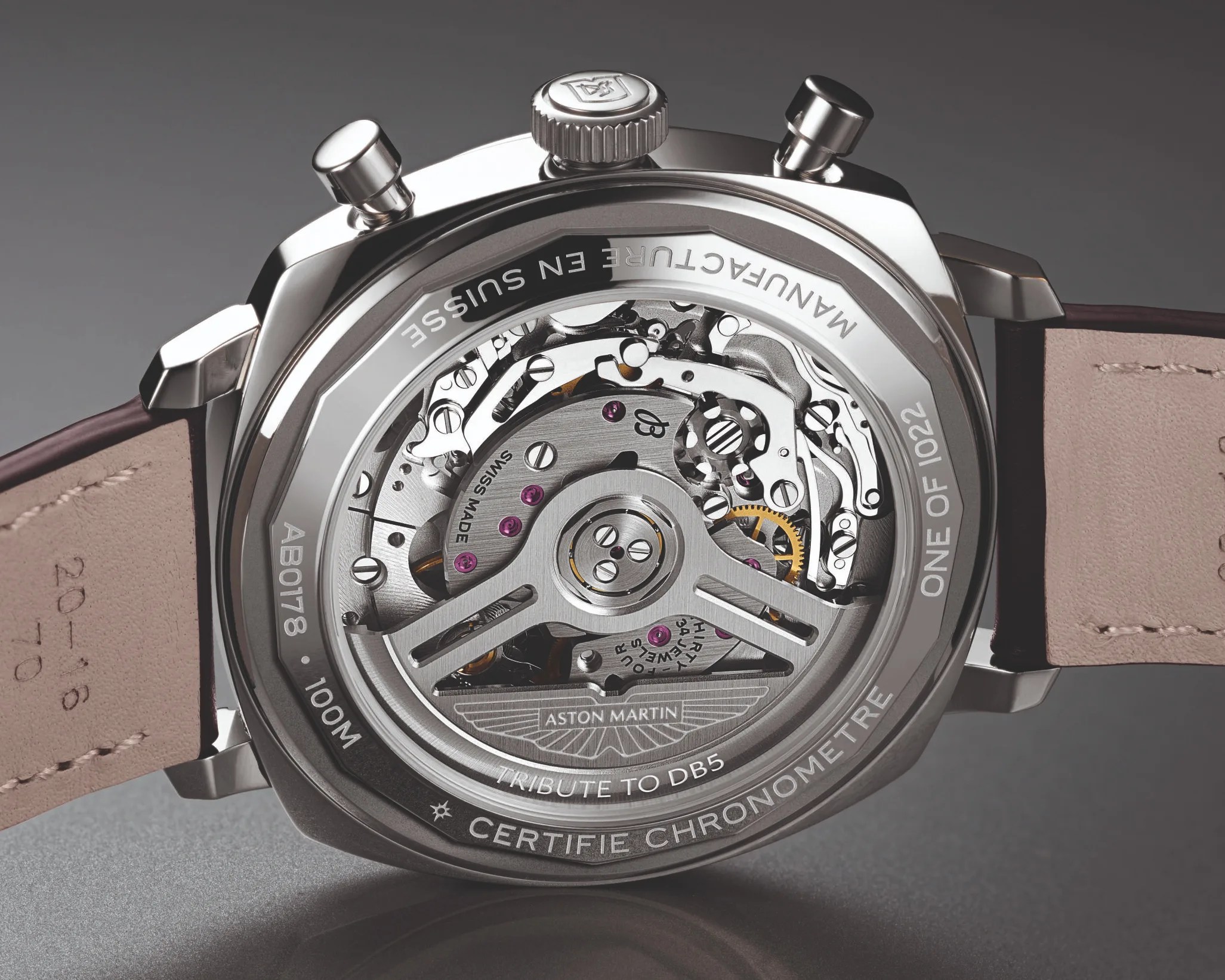 Close-up of the back of an Aston Martin Tribute to DB5 watch showing the intricate mechanical movement and leather strap.