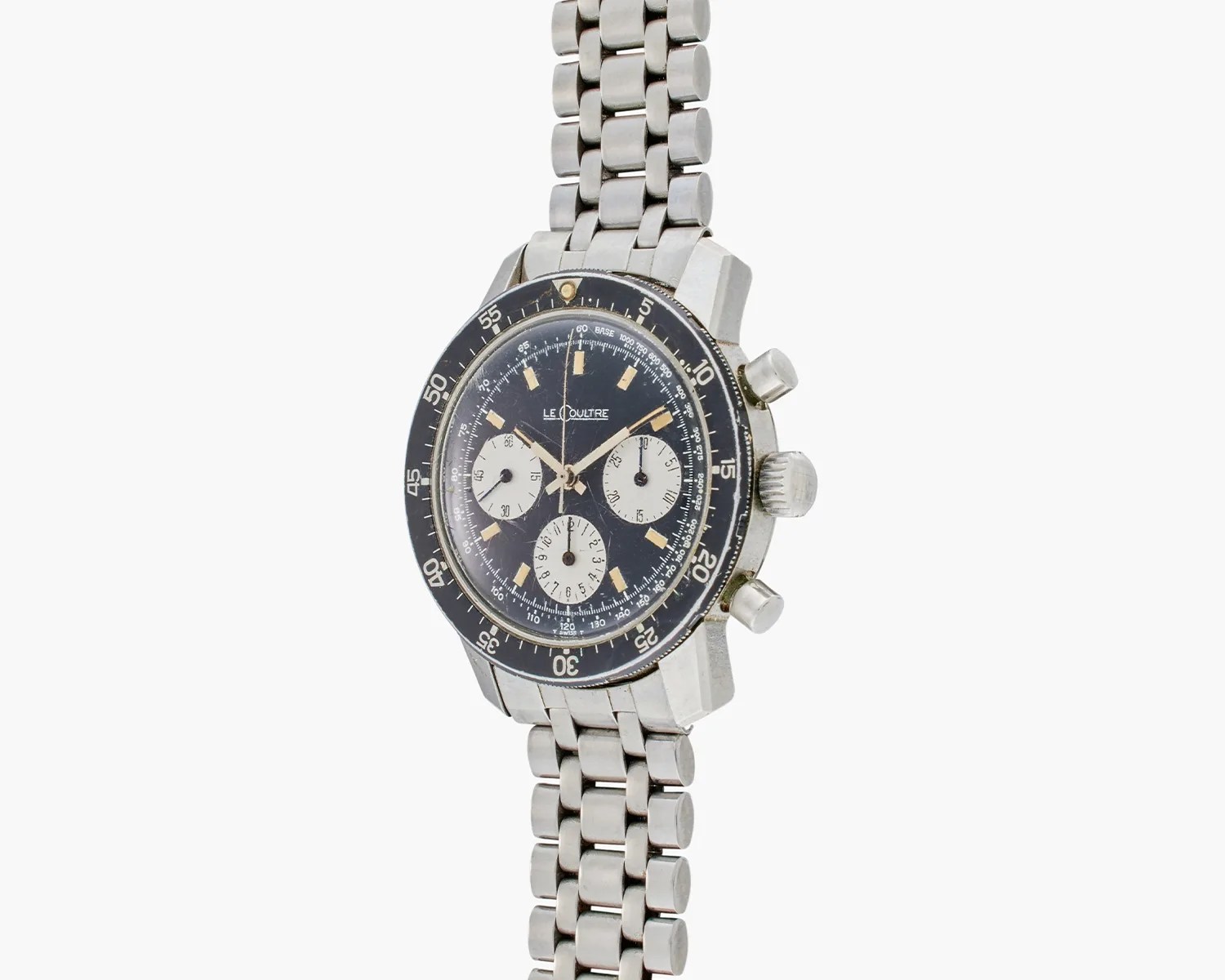 Vintage LeCoultre stainless steel chronograph wristwatch with black dial and three white subdials on a metal link bracelet.