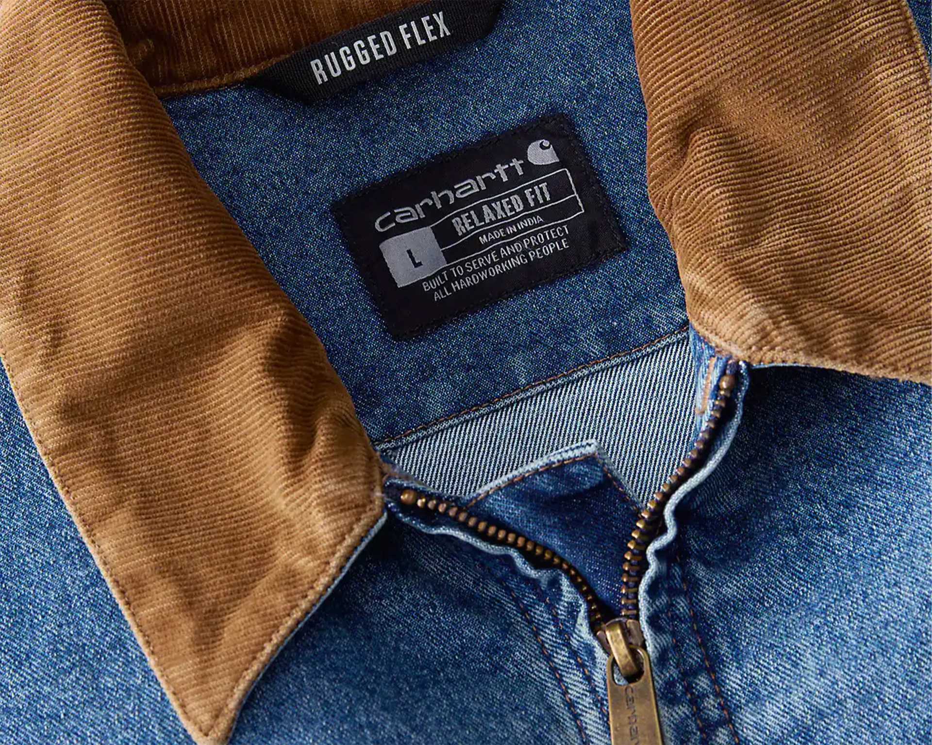Denim jacket with brown corduroy collar and visible Carhartt label reading "Relaxed Fit" and "Rugged Flex.