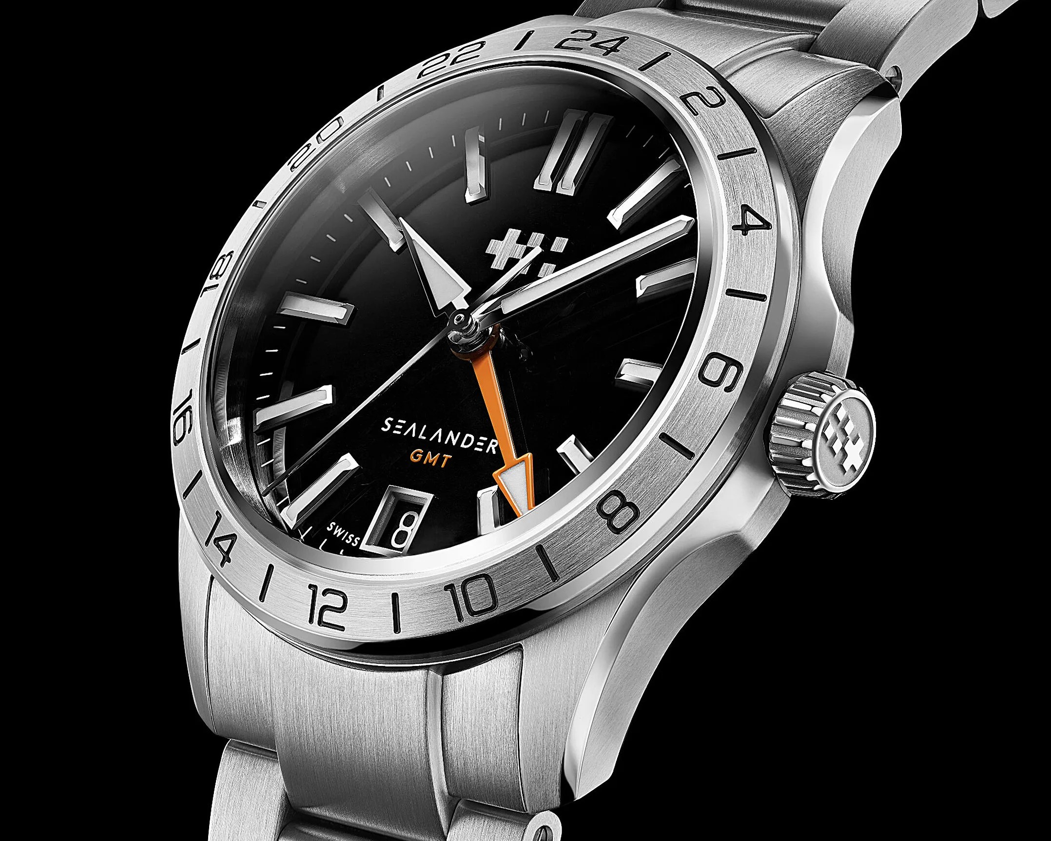 Close-up of a stainless steel Sealander GMT wristwatch with a black dial, orange GMT hand, and date window at 6 o'clock.
