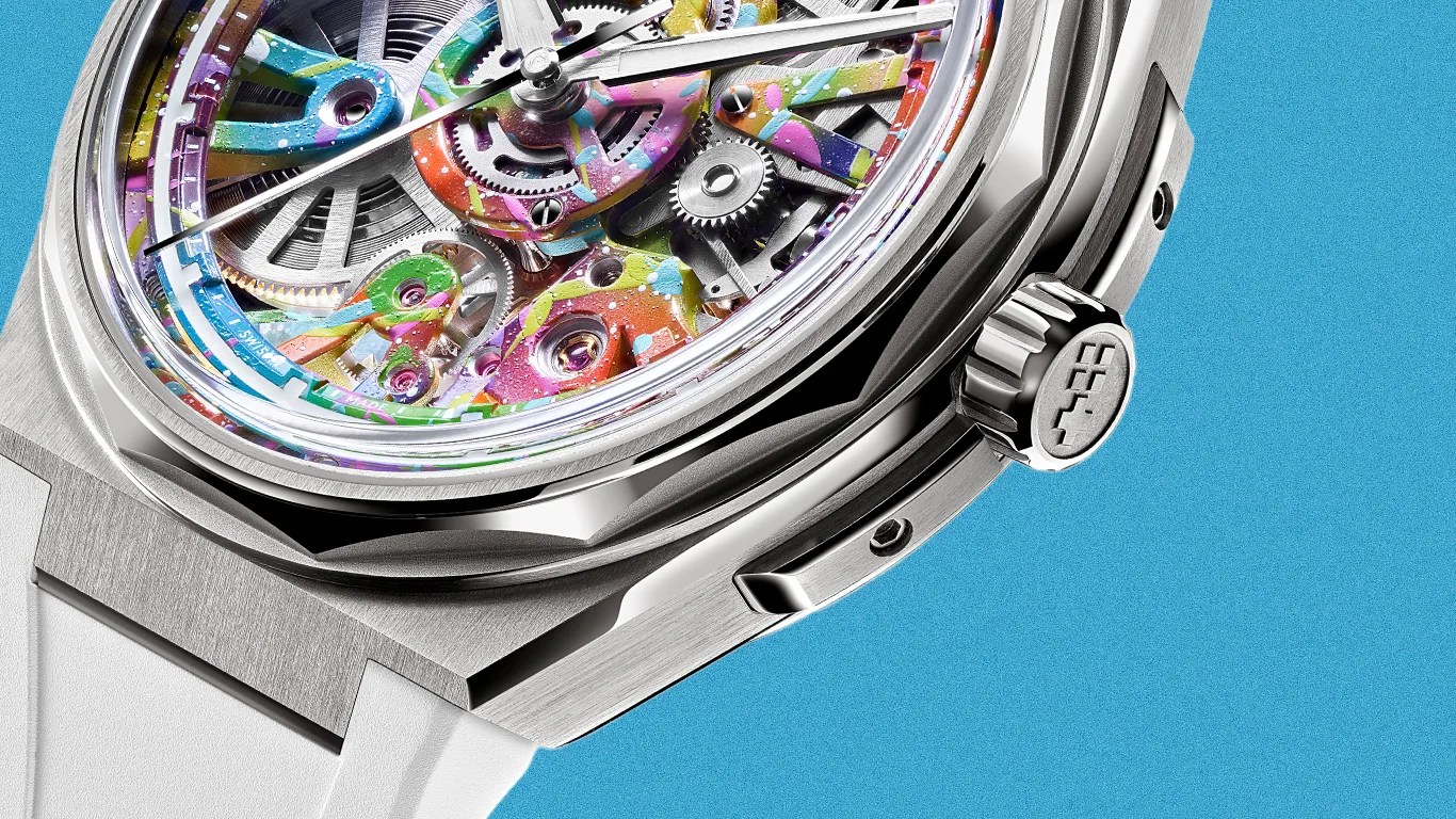 Close-up of a silver mechanical watch with a colorful skeleton dial and a white strap against a blue background.