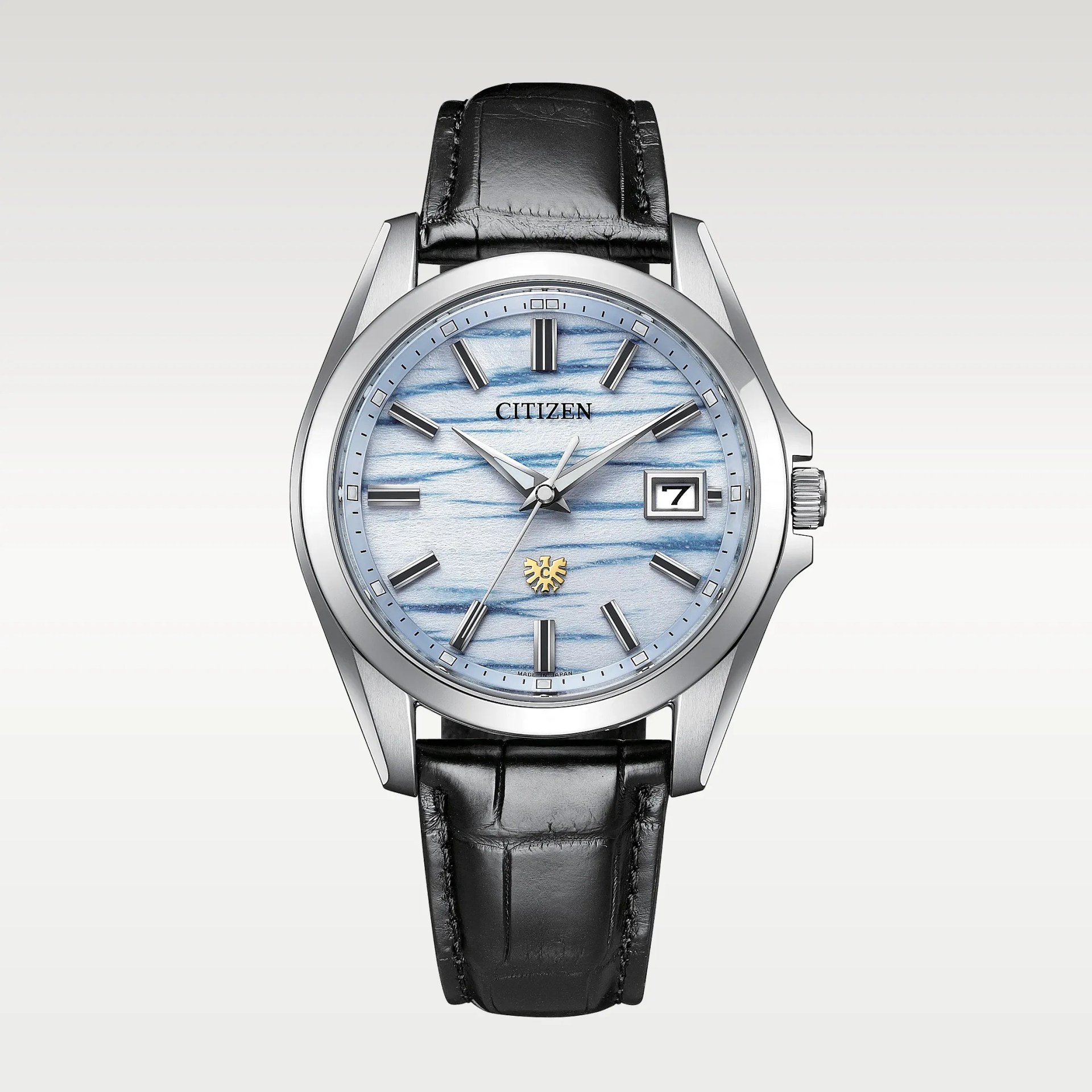 Silver Citizen wristwatch with blue textured dial, black leather strap, and date display at 3 o'clock.