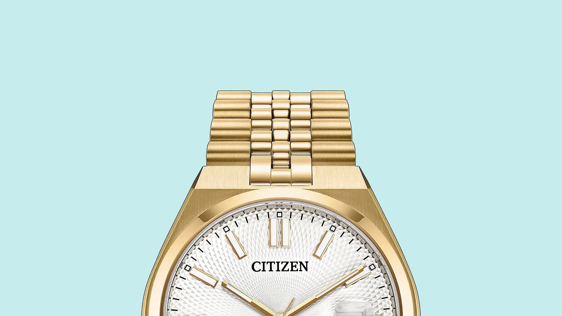 Gold metal link watch band attached to a gold watch case with a white textured dial.
