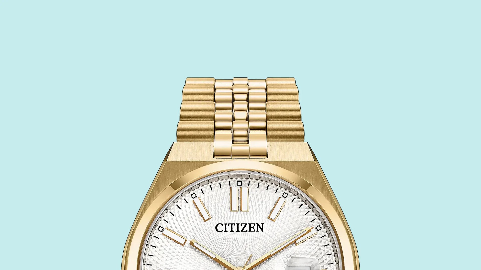 Gold metal link watch band attached to a gold watch case with a white textured dial.