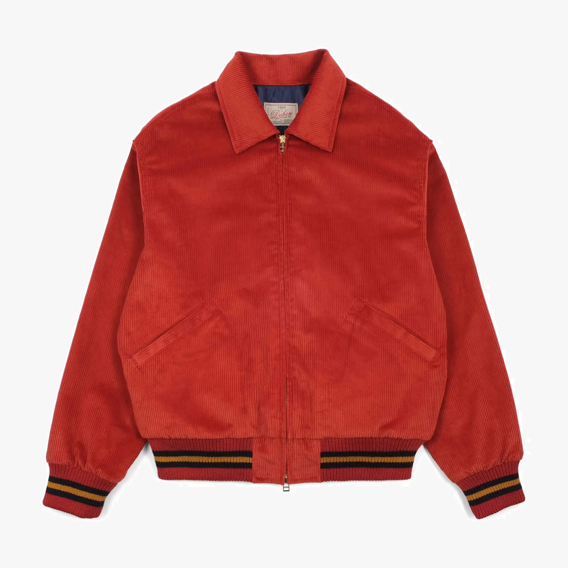 Rust red corduroy bomber jacket with striped ribbed cuffs and hem and front zipper closure.