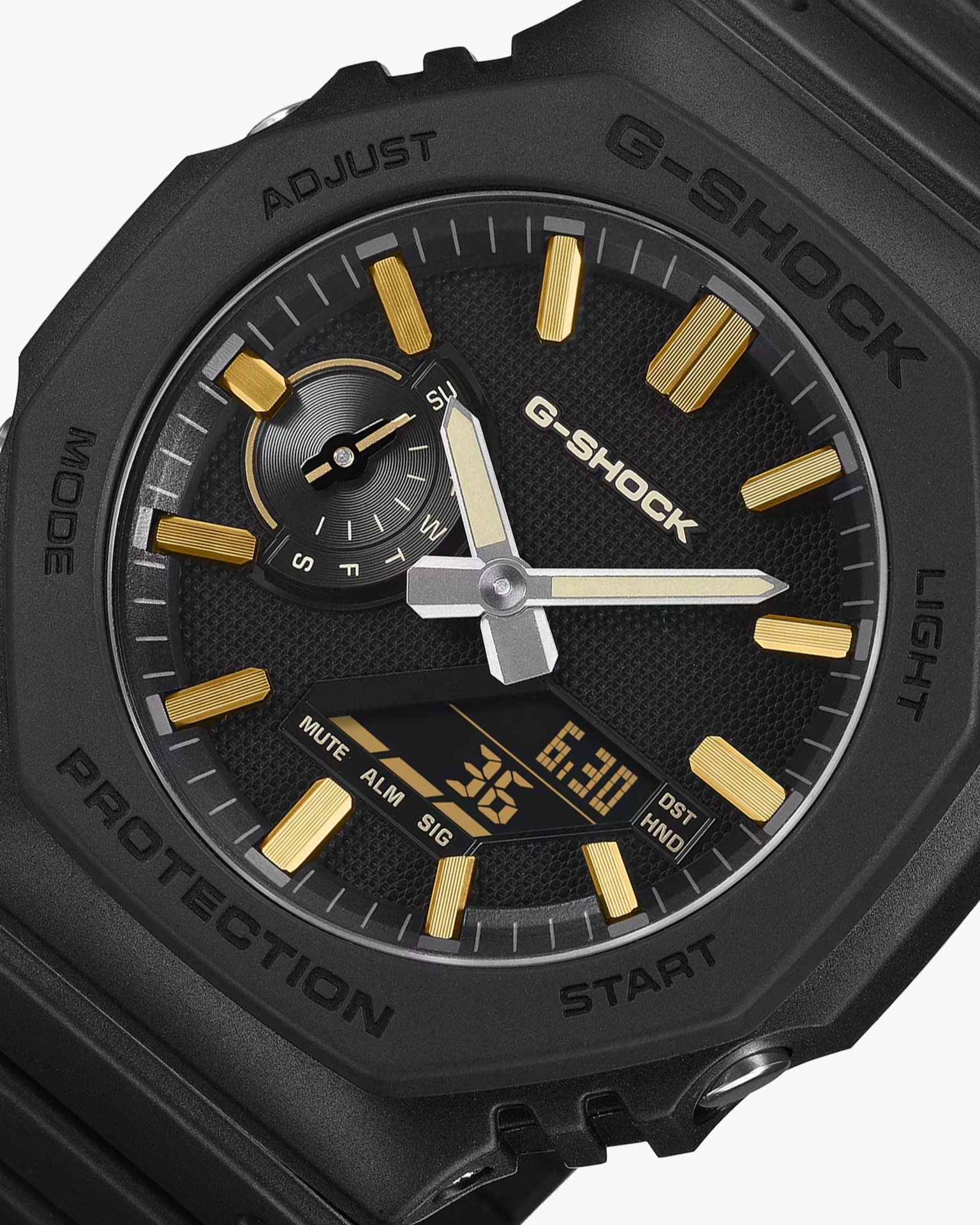 Black G-Shock watch face with gold hour markers, silver hands, and digital display showing date and time.