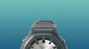 Black Casio G-Shock watch with silver dial and white hands against a blue gradient background.