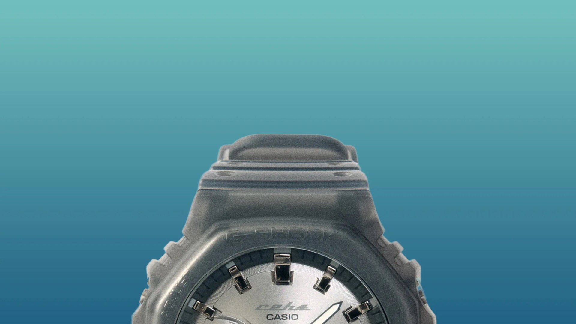 Black Casio G-Shock watch with silver dial and white hands against a blue gradient background.