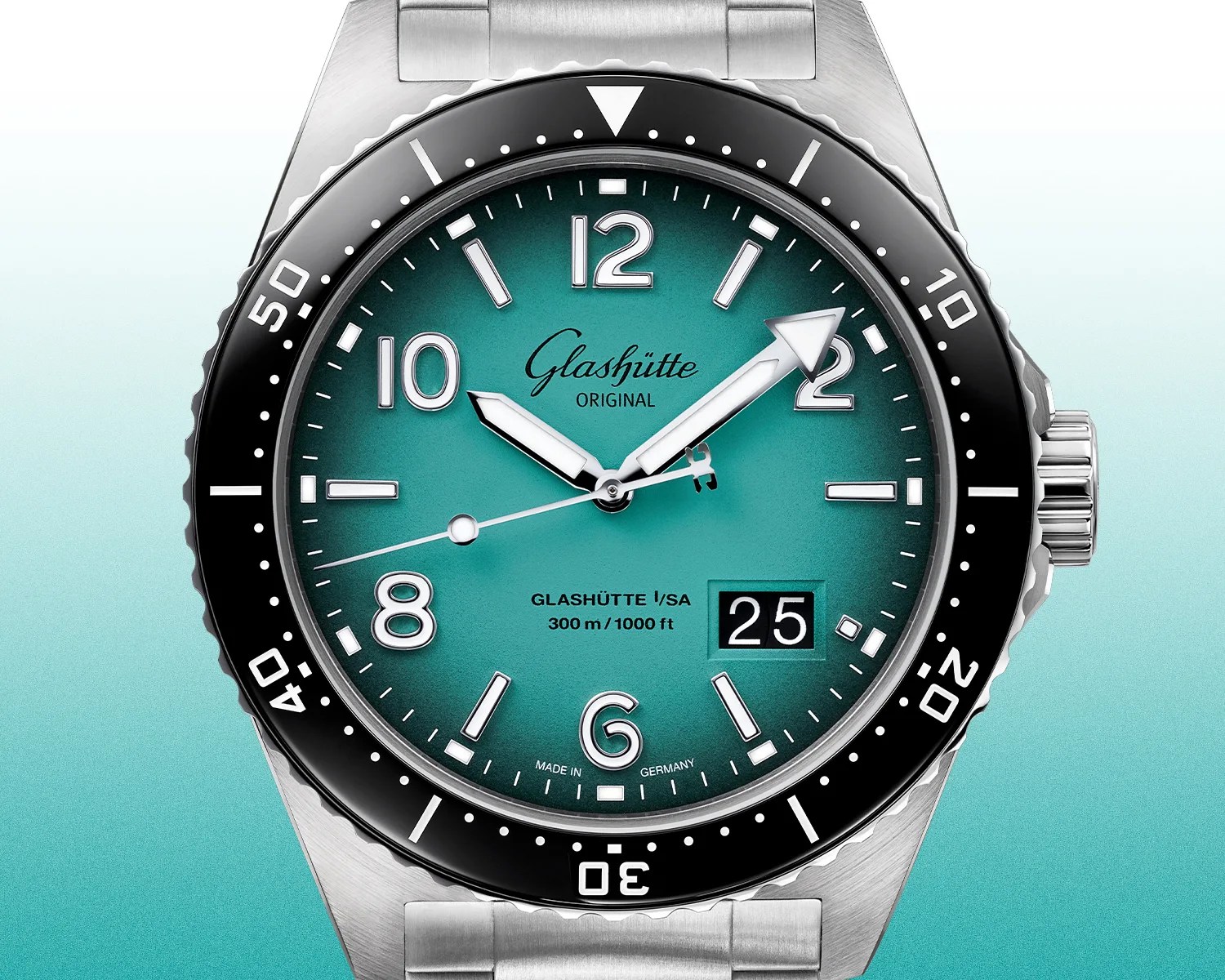 Close-up of a Glashütte Original watch with a turquoise dial, black bezel, silver markers, and date display at 3 o'clock.