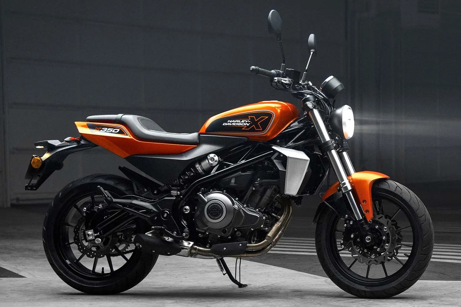 Orange and black Harley-Davidson X350 motorcycle with a round headlight and black alloy wheels.