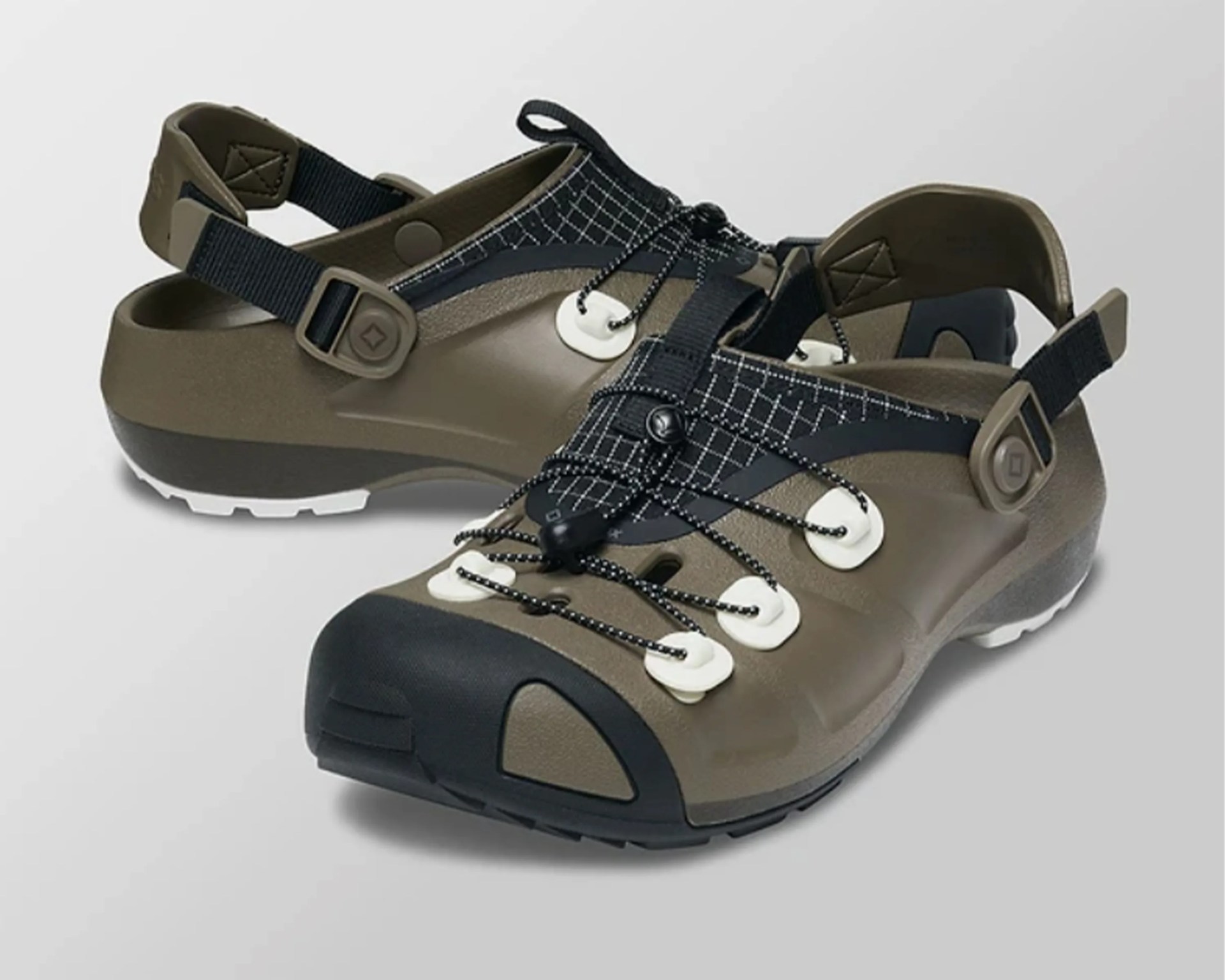 Olive green and black outdoor sandals with adjustable straps and bungee laces on a white background.